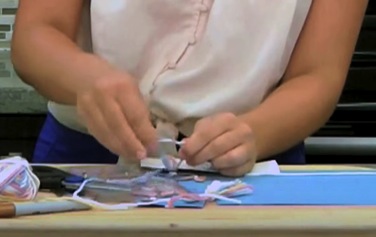 Demonstrating how to make the bookmark's tassel