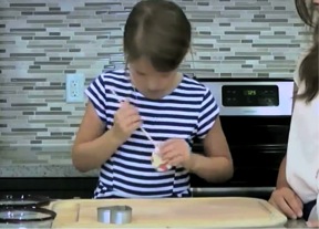 Kid demonstrating how to make a hole in the plant market