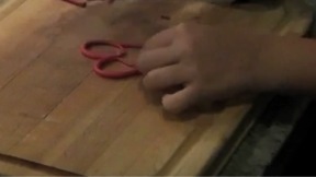 Demonstrating how to add loops to the heart pendant