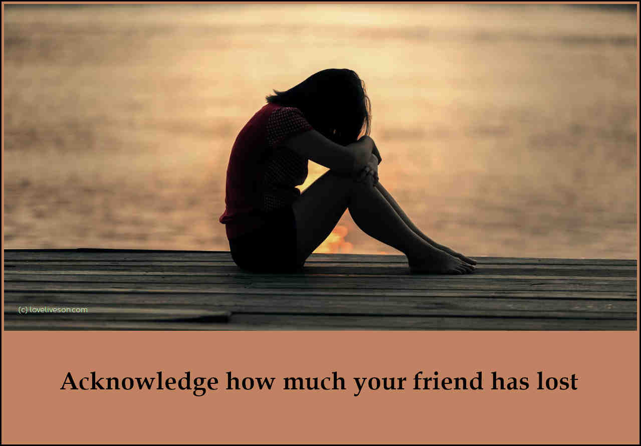 Shareable graphic meme with text overlay that says how to help someone who is grieving - acknowledge how much your friend has lost. Background is a woman huddled in grief while sitting on a dock.