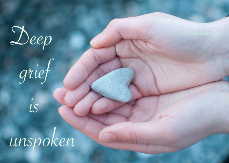 Shareable graphic meme with text overlay that says deep grief is unspoken - a grief definition. The background is two hands holding a heart shaped rock.