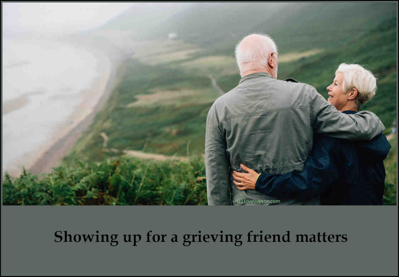 Shareable graphic meme with text overlay that says how to help someone who is grieving - showing up for a grieving friend matters. Background is a an elderly man comforting an elderly woman overlooking the beach from a cliff top.