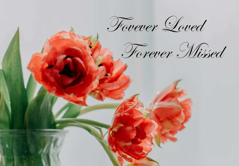 Shareable graphic meme with text overlay that says Forever Loved Forever Missed. Background is red tulips in a vase.